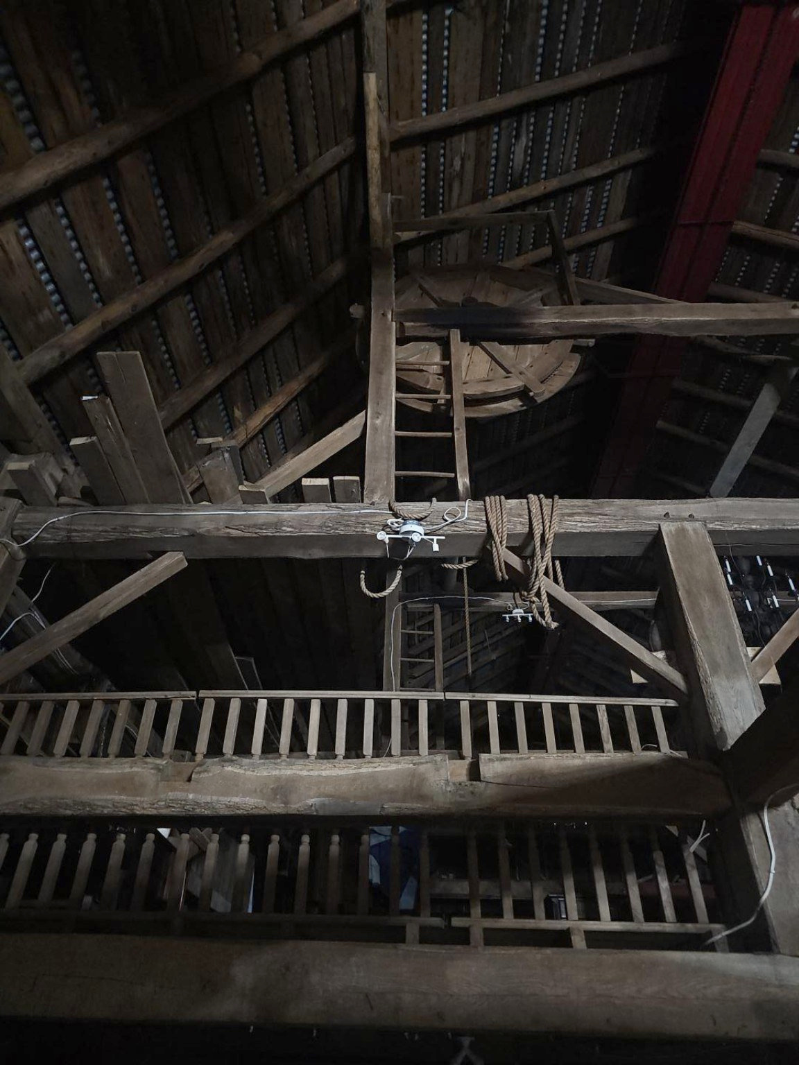 Roof beams, loft ladder and pulley detail inside the barn