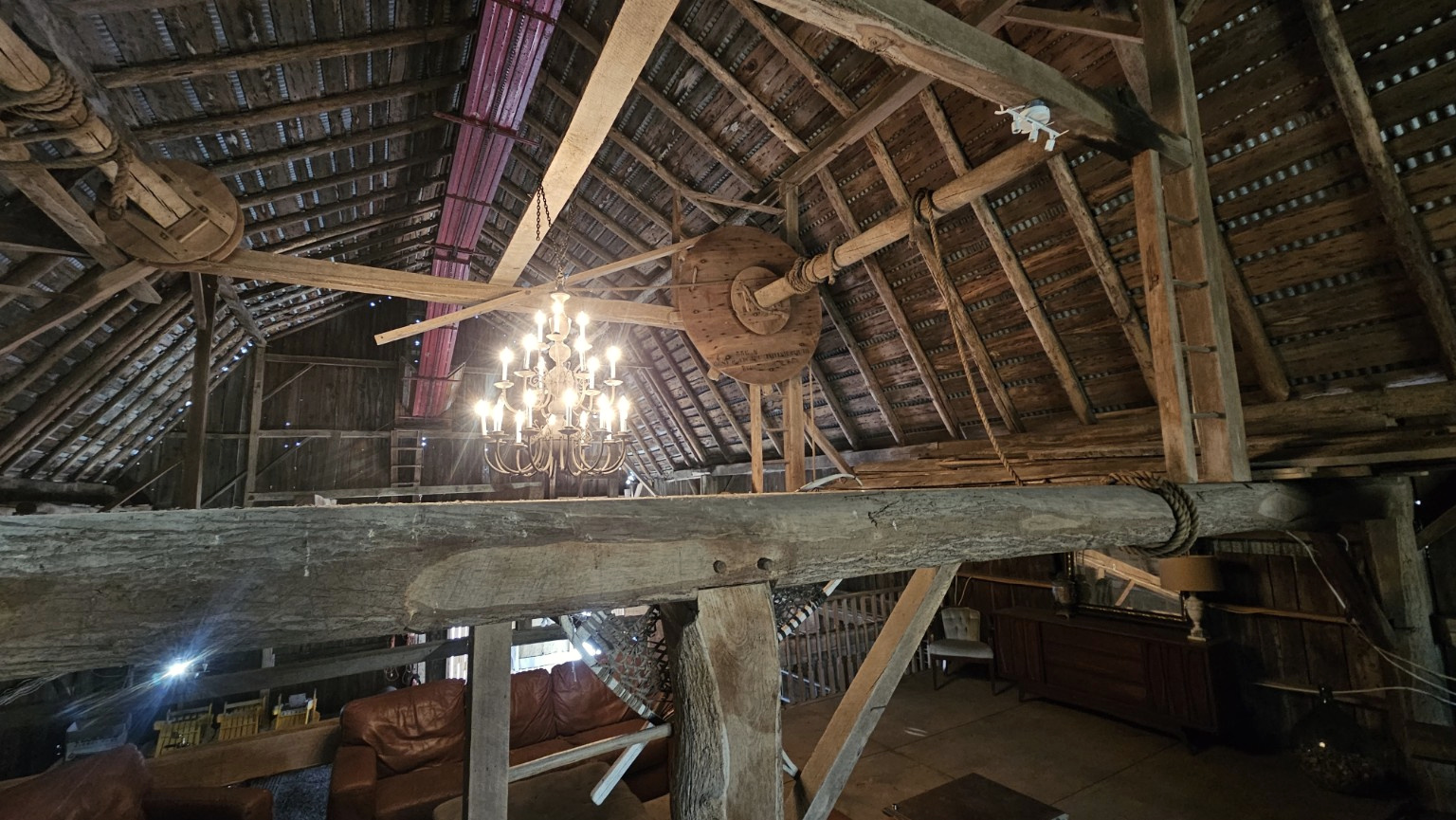 Historic wooden pulley and hoist above the barn floor