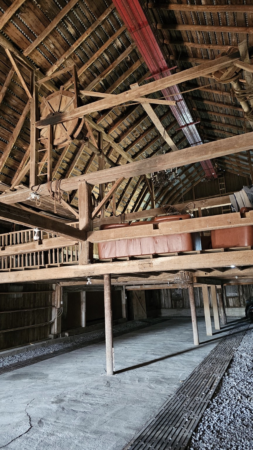 Open timber barn floor with posts and beams